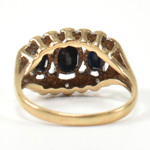 206 - A 9ct gold, sapphire and diamond three stone ring. The ring set with three graduating oval cut sapph... 