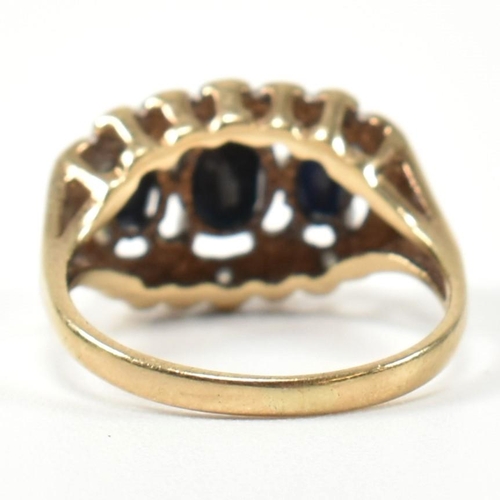 206 - A 9ct gold, sapphire and diamond three stone ring. The ring set with three graduating oval cut sapph... 