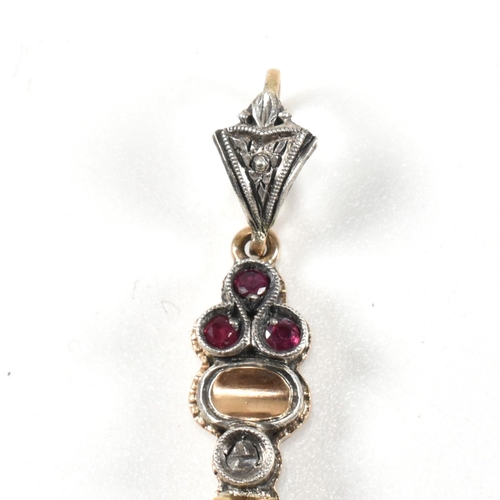 209 - French ruby and diamond cross pendant. The pendant set with rubies and diamonds with bale to top. Un... 