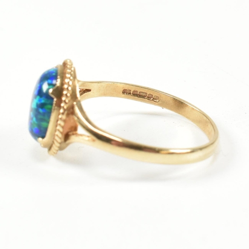 220 - A hallmarked 9ct gold and amethyst ring and a hallmarked 9ct gold and synthetic opal ring. The dress... 