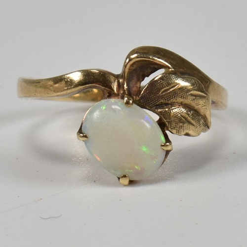 222 - A 9ct and opal ring. The ring having a four claw set oval opal cabochon set surmounted above a gold ... 