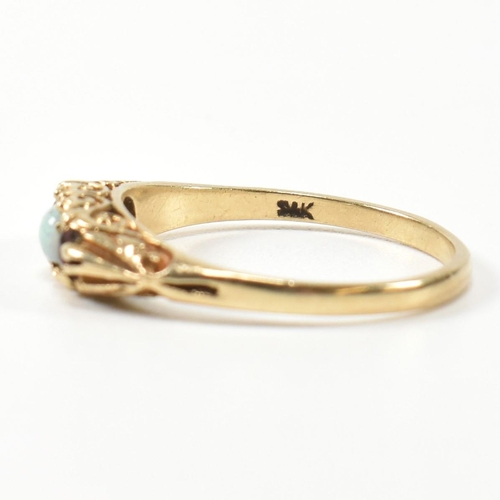 224 - A 1940s hallmarked 9ct gold, opal and garnet three stone gypsy ring. The ring having a central round... 