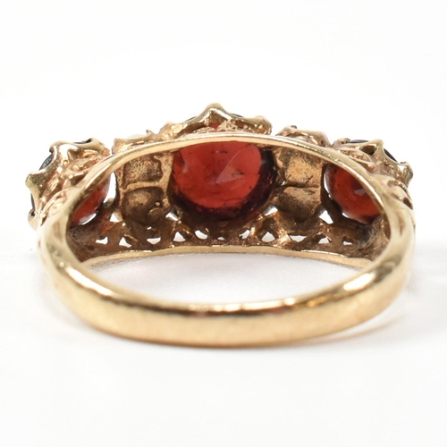 230 - A 1960s hallmarked 9ct gold, garnet and pearl half hoop ring. The ring having three graduating round... 