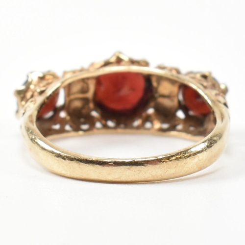 230 - A 1960s hallmarked 9ct gold, garnet and pearl half hoop ring. The ring having three graduating round... 