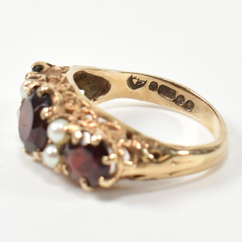 230 - A 1960s hallmarked 9ct gold, garnet and pearl half hoop ring. The ring having three graduating round... 