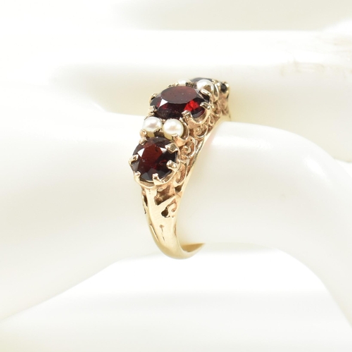 230 - A 1960s hallmarked 9ct gold, garnet and pearl half hoop ring. The ring having three graduating round... 