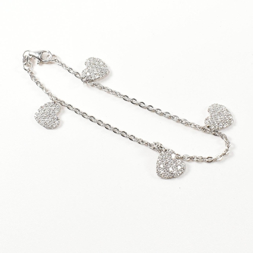 232 - A hallmarked 9ct white gold and CZ heart charm bracelet. The cable link chain bracelet having four C... 