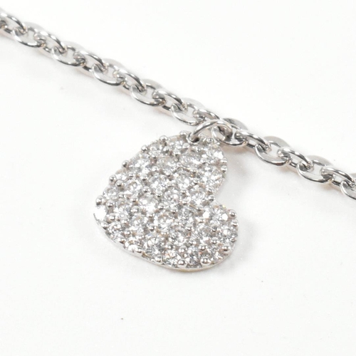 232 - A hallmarked 9ct white gold and CZ heart charm bracelet. The cable link chain bracelet having four C... 