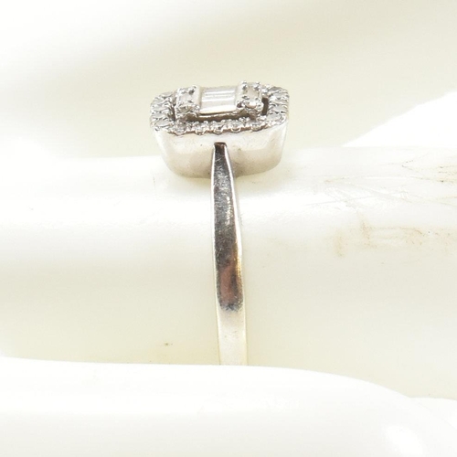 237 - A 9ct white gold and diamond ring. The ring set with five baguette cut diamonds and four round cut d... 