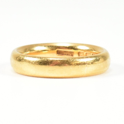 24 - A hallmarked 22ct gold band ring. Hallmarked for London, 1921. Size K.5-L. Weighs 7.6g. All weights,... 