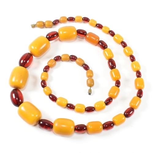 247 - A 20th century yellow and cherry Bakelite bead necklace. The necklace having thirty one graduating b... 