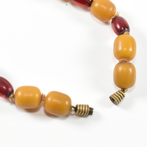 247 - A 20th century yellow and cherry Bakelite bead necklace. The necklace having thirty one graduating b... 