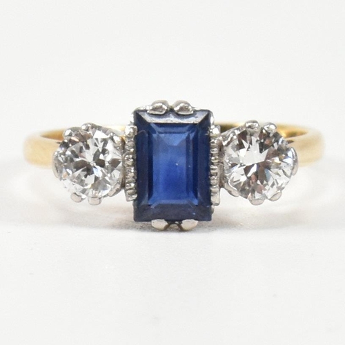 248 - An 18ct gold, sapphire and diamond three stone ring. The ring having a central baguette cut sapphire... 