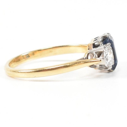 248 - An 18ct gold, sapphire and diamond three stone ring. The ring having a central baguette cut sapphire... 