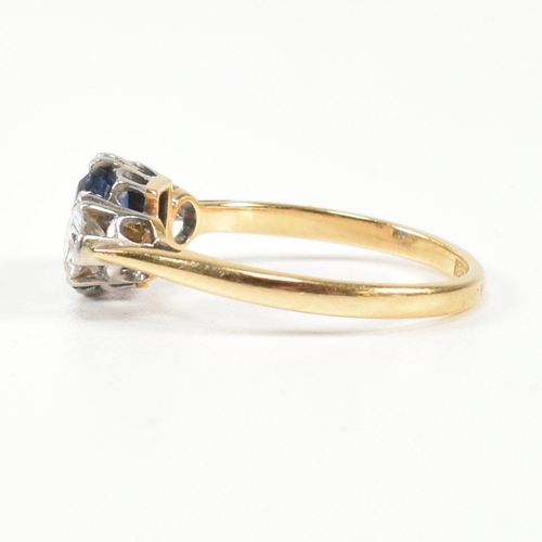 248 - An 18ct gold, sapphire and diamond three stone ring. The ring having a central baguette cut sapphire... 