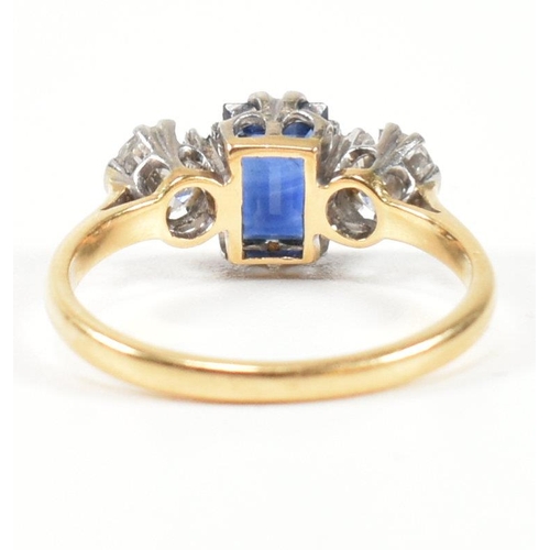 248 - An 18ct gold, sapphire and diamond three stone ring. The ring having a central baguette cut sapphire... 