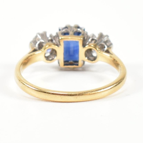 248 - An 18ct gold, sapphire and diamond three stone ring. The ring having a central baguette cut sapphire... 