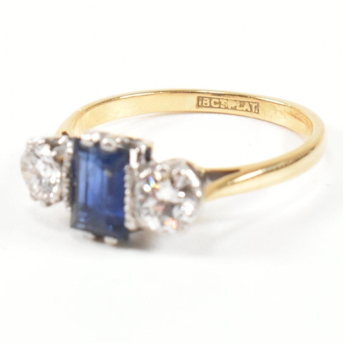 248 - An 18ct gold, sapphire and diamond three stone ring. The ring having a central baguette cut sapphire... 