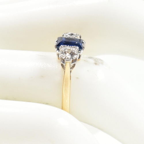 248 - An 18ct gold, sapphire and diamond three stone ring. The ring having a central baguette cut sapphire... 