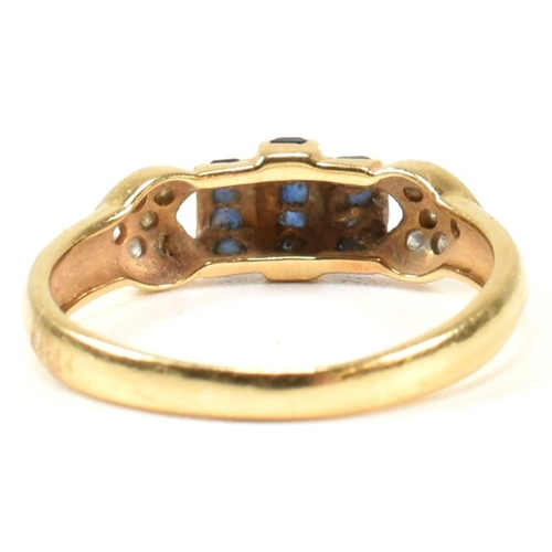 250A - An 18ct yellow gold sapphire and diamond ring. The ring having central domed calibre cut sapphires t... 