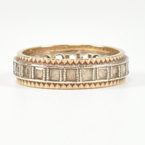 251 - A hallmarked 9ct gold and white stone eternity ring. The two tone metal ring set with a central row ... 