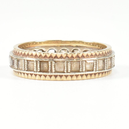 251 - A hallmarked 9ct gold and white stone eternity ring. The two tone metal ring set with a central row ... 