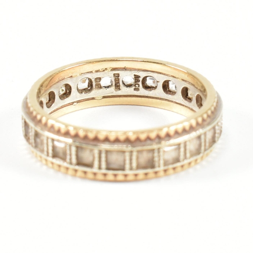 251 - A hallmarked 9ct gold and white stone eternity ring. The two tone metal ring set with a central row ... 