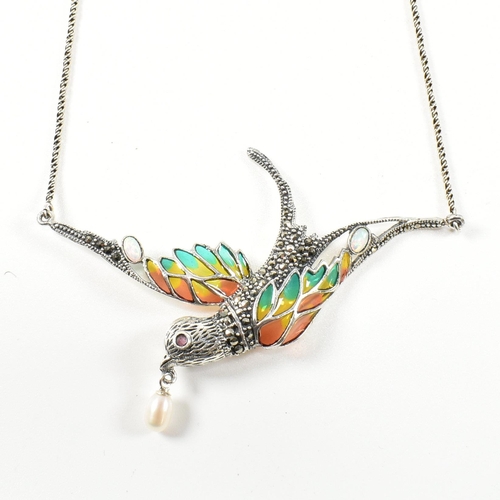 253 - A silver plique-a-jour bird in flight necklace. The necklace having a silver and plique-a-jour swall... 