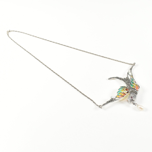 253 - A silver plique-a-jour bird in flight necklace. The necklace having a silver and plique-a-jour swall... 