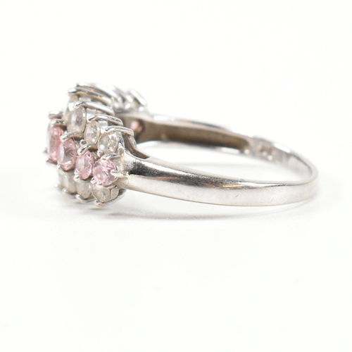 270 - A hallmarked 9ct white gold and CZ cluster ring. The cluster ring having two rows of eight graduatin... 