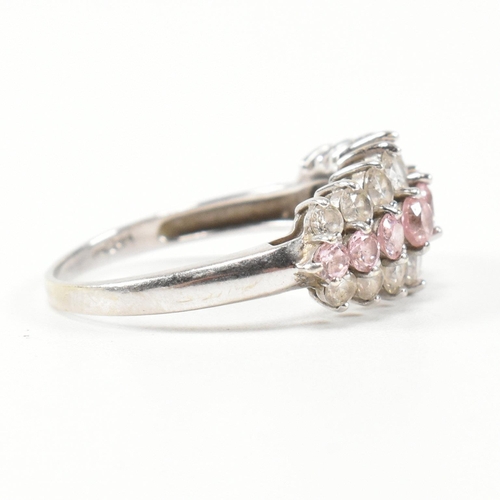 270 - A hallmarked 9ct white gold and CZ cluster ring. The cluster ring having two rows of eight graduatin... 