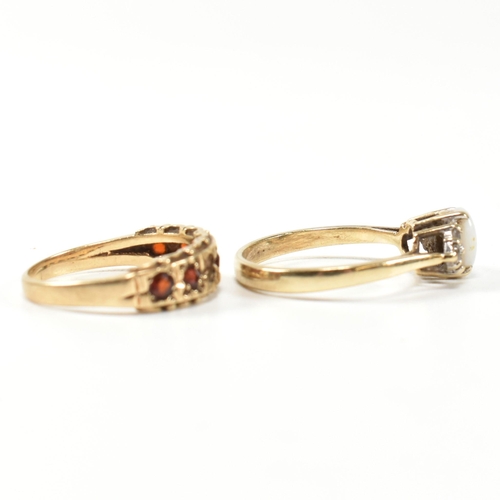 274 - Two hallmarked gold and gem set rings. The rings to include a hallmarked 9ct gold, opal and CZ ring,... 