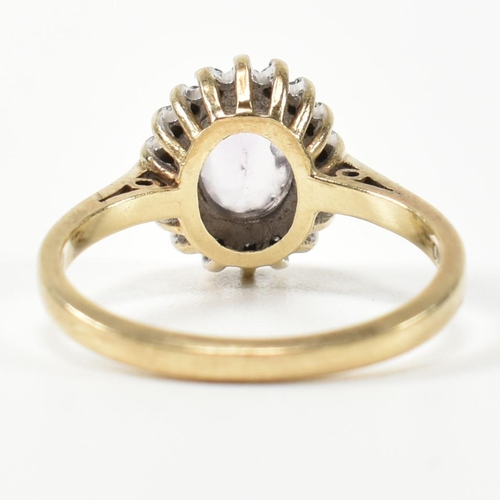 294 - A hallmarked 9ct gold, diamond and amethyst cluster ring. The 9ct gold cluster ring set with a centr... 