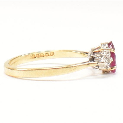 30 - A hallmarked 18ct gold, ruby and diamond ring. The ring set with a central oval cut ruby flanked by ... 