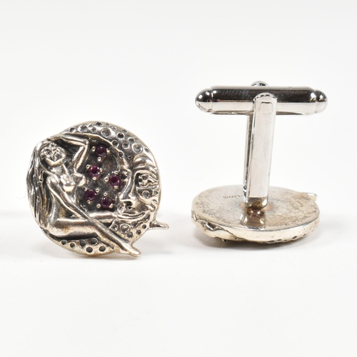 301 - A pair of sterling silver maiden and moon cufflinks set with synthetic ruby. Marked Sterling. Measur... 