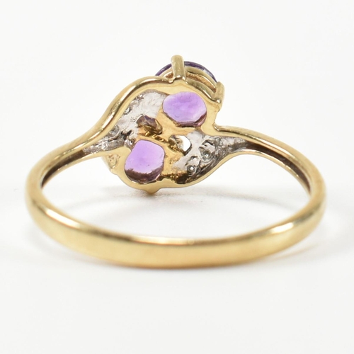 302 - A hallmarked 9ct gold, amethyst and diamond cross over ring. The ring having two round cut amethysts... 