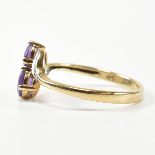 302 - A hallmarked 9ct gold, amethyst and diamond cross over ring. The ring having two round cut amethysts... 