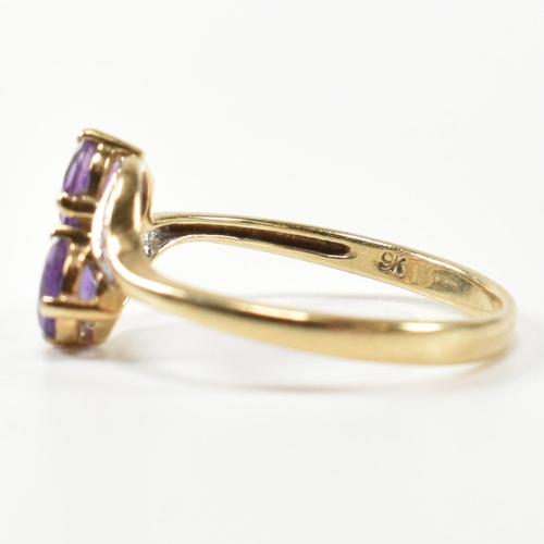 302 - A hallmarked 9ct gold, amethyst and diamond cross over ring. The ring having two round cut amethysts... 