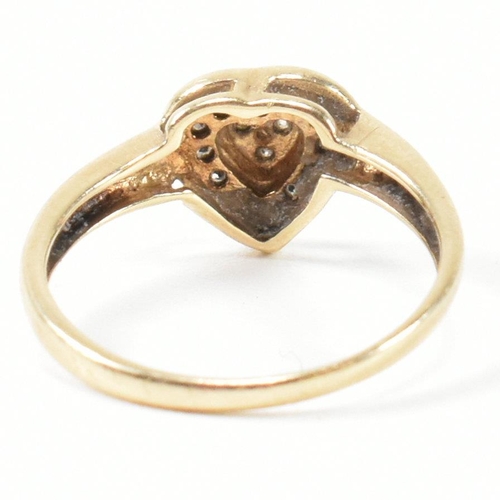 306 - A hallmarked 9ct gold and diamond heart cluster ring. The ring having three round cut diamonds to th... 