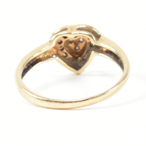 306 - A hallmarked 9ct gold and diamond heart cluster ring. The ring having three round cut diamonds to th... 