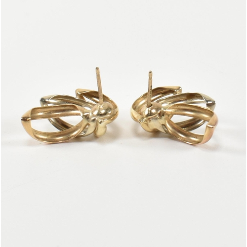 307 - A pair of hallmarked 9ct gold three tone wreath earrings. The stud earrings having a laurel wreath d... 