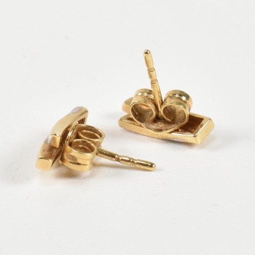 312 - A pair of 18ct gold and diamond stud earrings. The earrings having a two tone yellow and white gold ... 