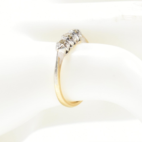 314 - A 9ct gold, platinum and diamond three stone ring. The ring having a single row of three round cut d... 