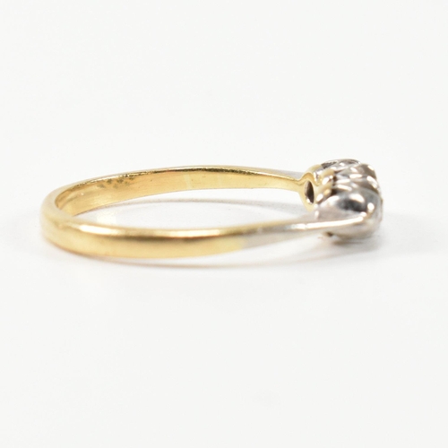 314 - A 9ct gold, platinum and diamond three stone ring. The ring having a single row of three round cut d... 