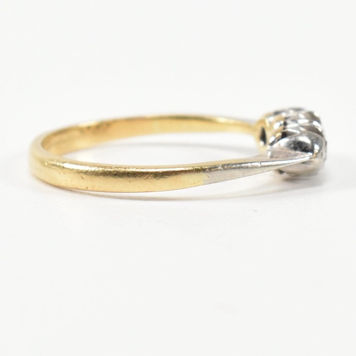 314 - A 9ct gold, platinum and diamond three stone ring. The ring having a single row of three round cut d... 