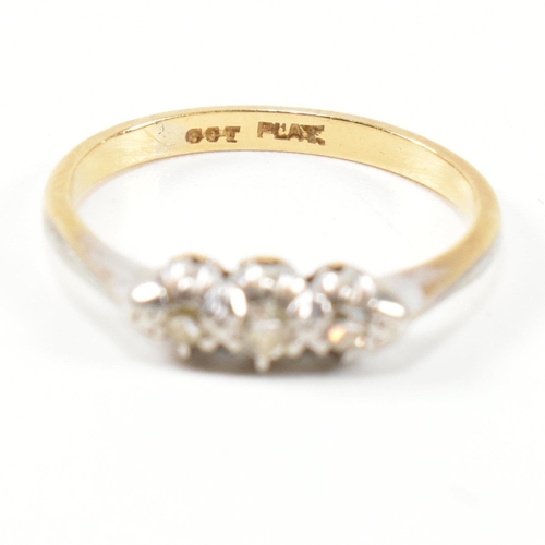 314 - A 9ct gold, platinum and diamond three stone ring. The ring having a single row of three round cut d... 