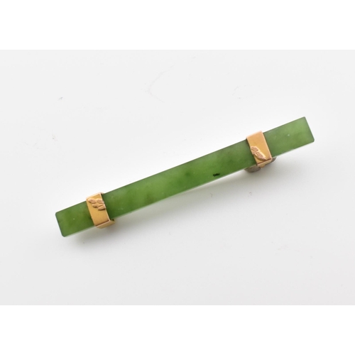 316 - A vintage nephrite & yellow metal bar brooch pin. The brooch comprised of a rectangular cut mottled ... 