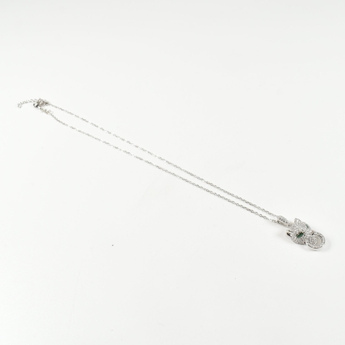 318 - A designer style silver pendant necklace. The necklace strung with a CZ encrusted leopard pendant. P... 