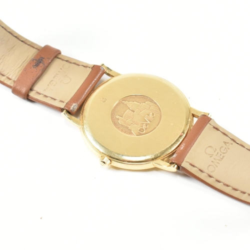 32 - An 18ct gold Omega De Ville wrist watch. The Omega watch having gold mixed Roman and stick indices, ... 