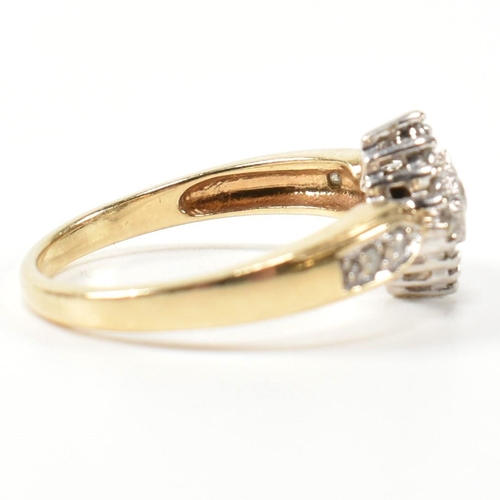 324 - A hallmarked 9ct gold and diamond cluster ring. The ring having a central round brilliant cut diamon... 